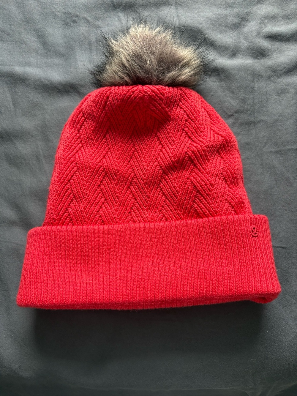 Lululemon coral colored knit beanie with Brown Faux-Fur Pom. Never worn.